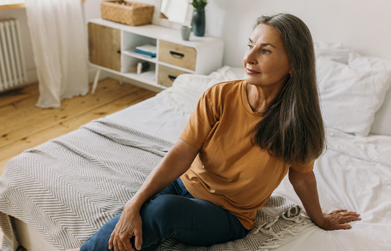 Woman sitting on bed