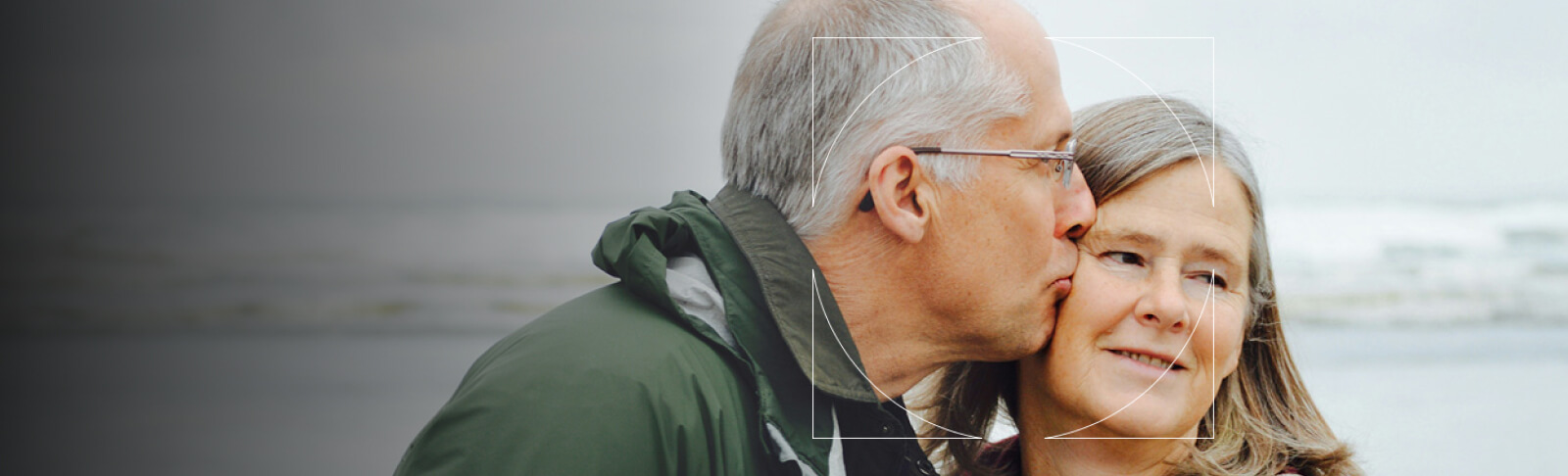 Elderly man kissing his wife on the cheek