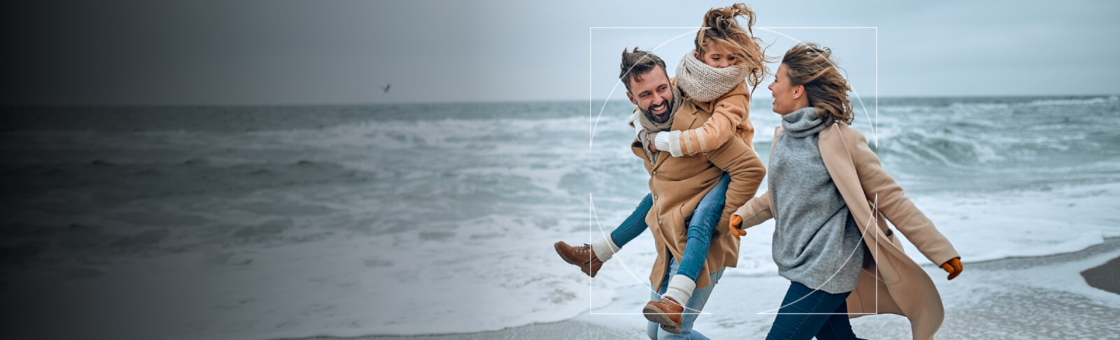 Family walking on the beach in the wind